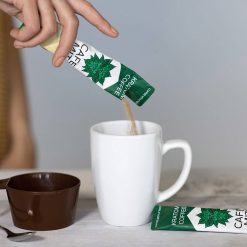 Cafe mit single serve kratom cofee packet being poured into a white coffee mug
